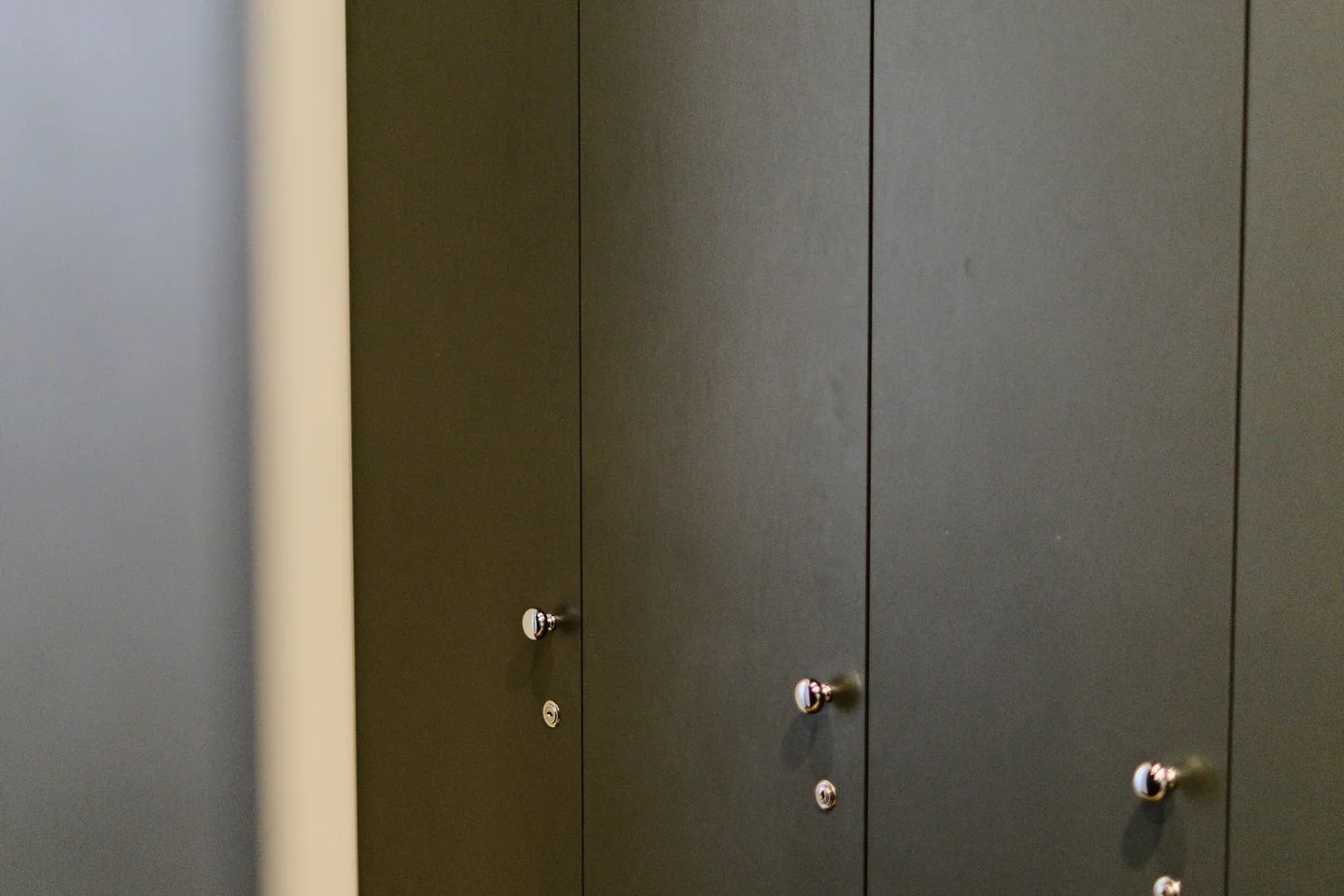 Dark lockers in a gym changing room.