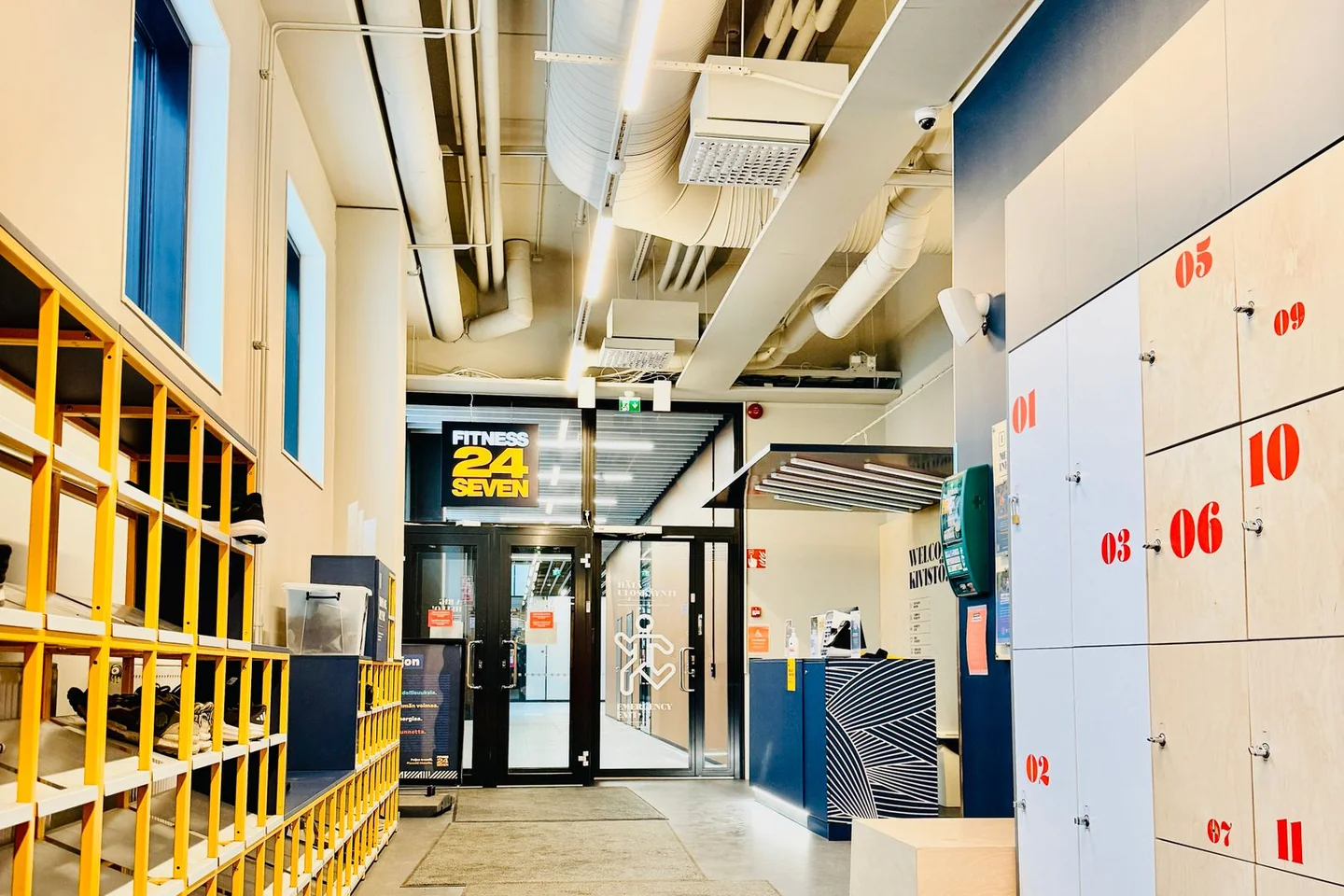 An entrance corridor with lockers and a reception area.