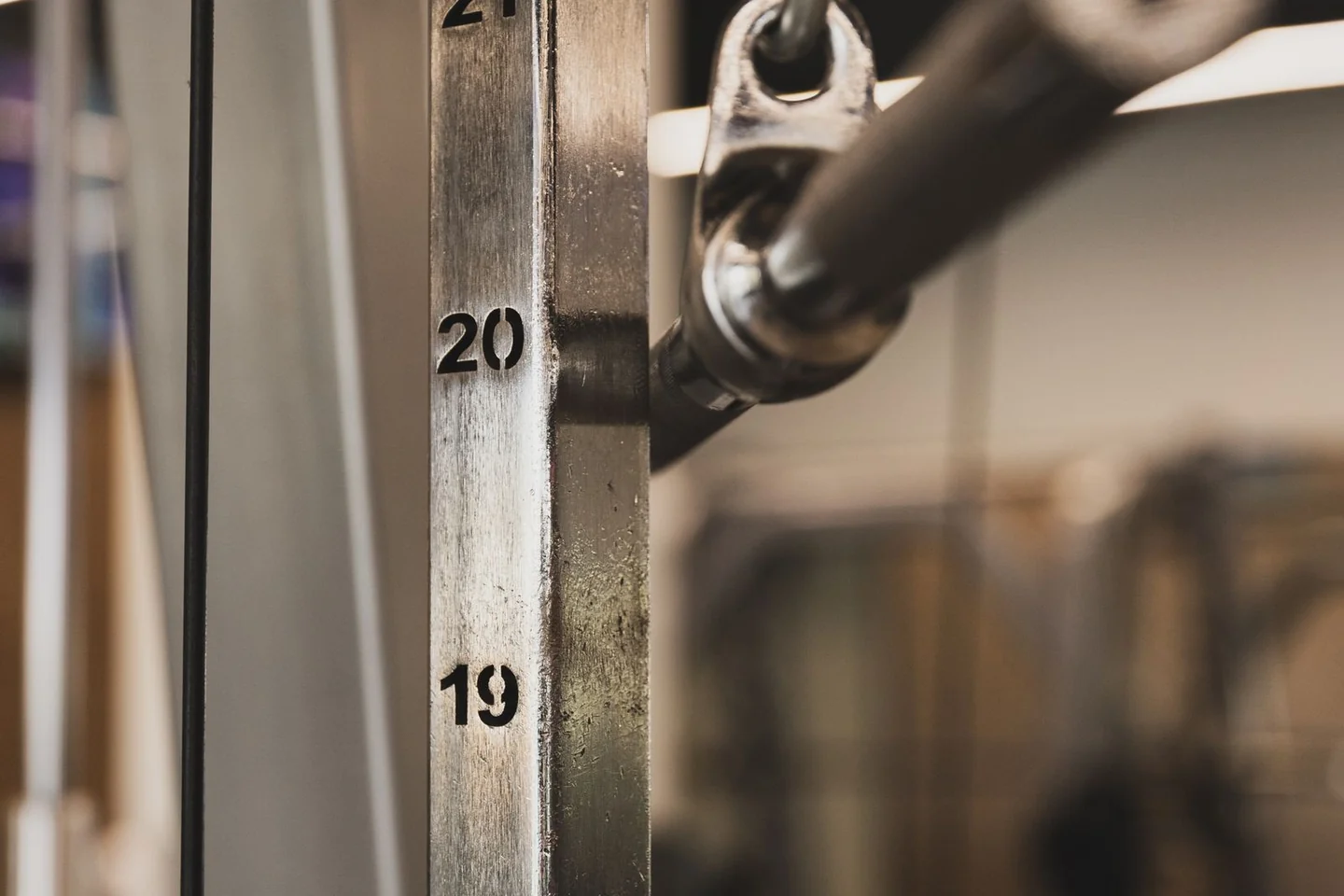 Close view of numbered plates in a gym weight stack.