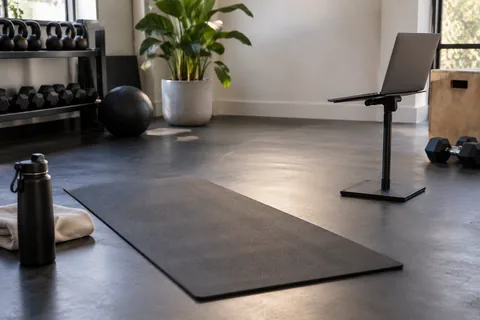 laptop on stand facing exercise mat.