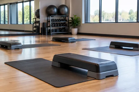 empty exercise studio mats and step platforms.