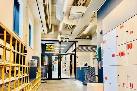 An entrance corridor with lockers and a reception area.