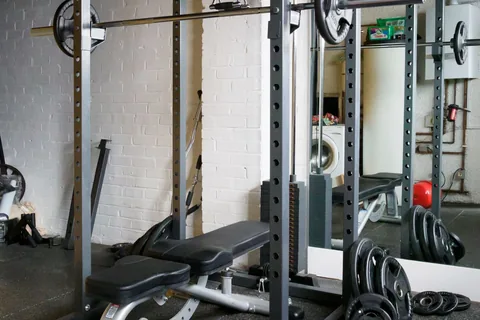 A weight bench and equipment in a home gym.