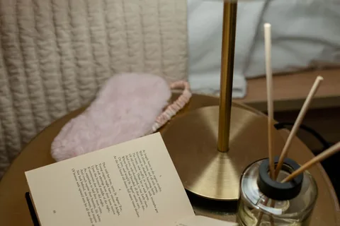 A bedside lamp and open book.